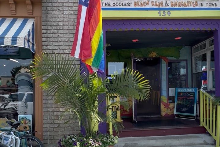 The Purple Parrot Grill storefront with flags on Rehoboth Avenue