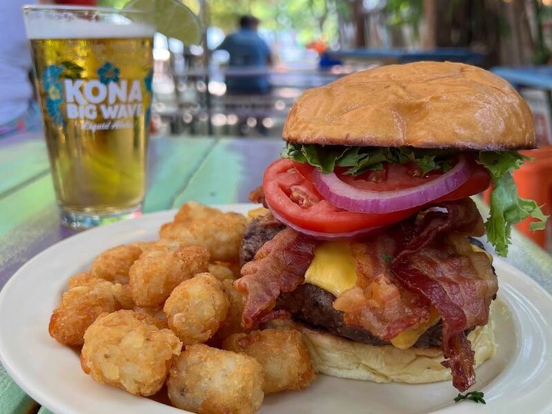 A Purple Parrot burger with bacon and tater tots